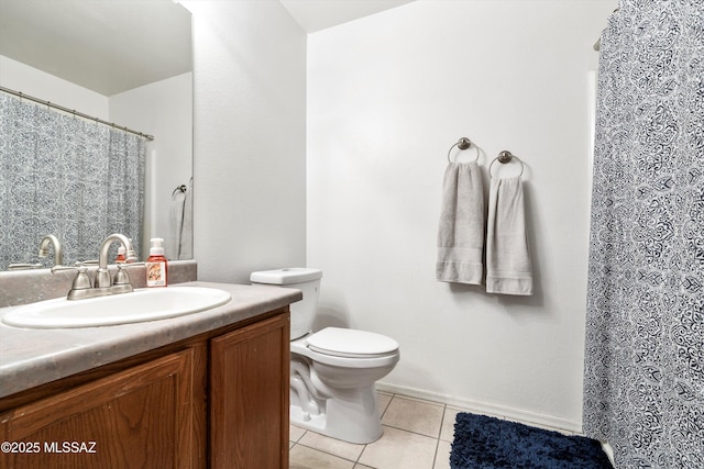 bathroom with curtained shower, toilet, vanity, and tile patterned flooring