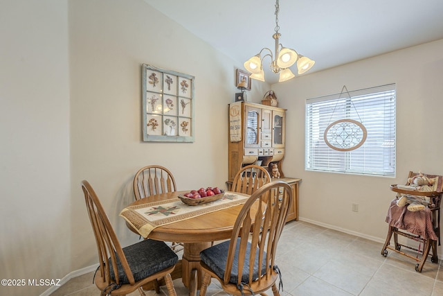 dining area featuring light tile patterned floors, baseboards, and a chandelier