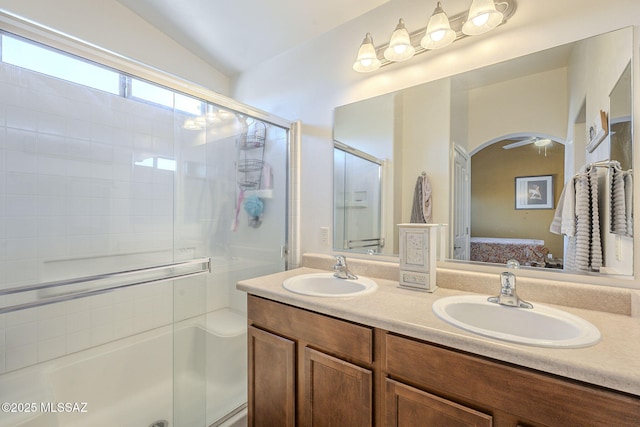 full bath featuring double vanity, a shower stall, ensuite bathroom, and a sink