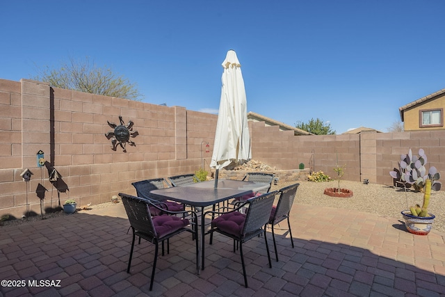 view of patio with outdoor dining area and a fenced backyard