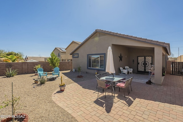 view of patio with outdoor dining area and a fenced backyard