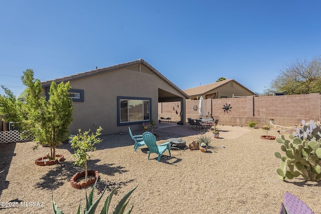 back of property featuring stucco siding, a fenced backyard, and a patio area