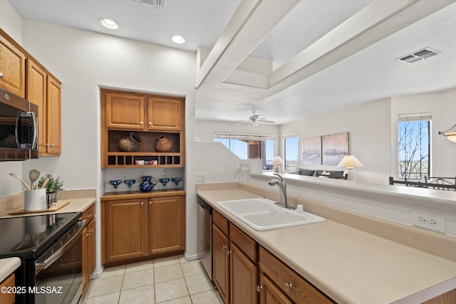 kitchen featuring visible vents, a sink, light countertops, appliances with stainless steel finishes, and brown cabinets