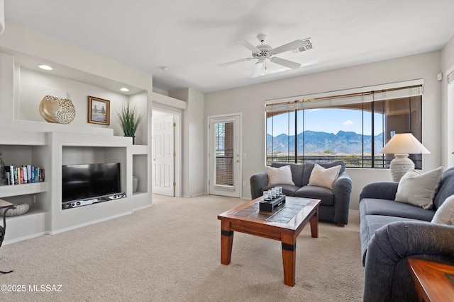 living area featuring visible vents, built in shelves, ceiling fan, light carpet, and recessed lighting