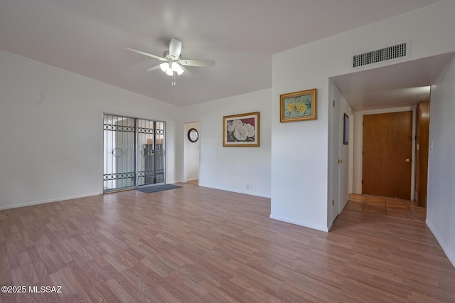 empty room with light wood finished floors, visible vents, baseboards, and ceiling fan