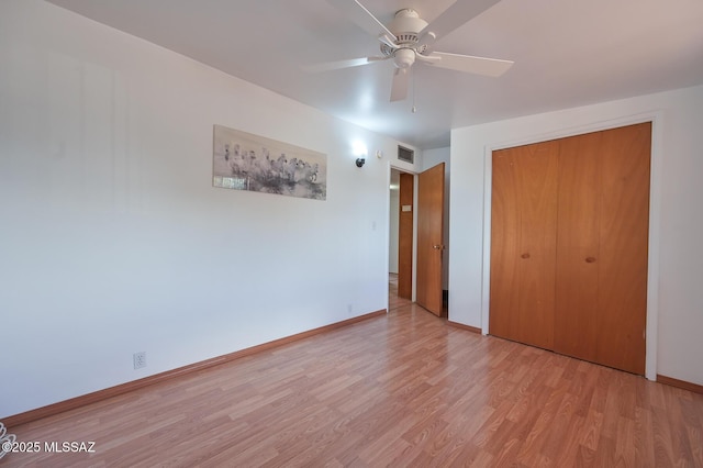 unfurnished bedroom with visible vents, baseboards, light wood finished floors, ceiling fan, and a closet