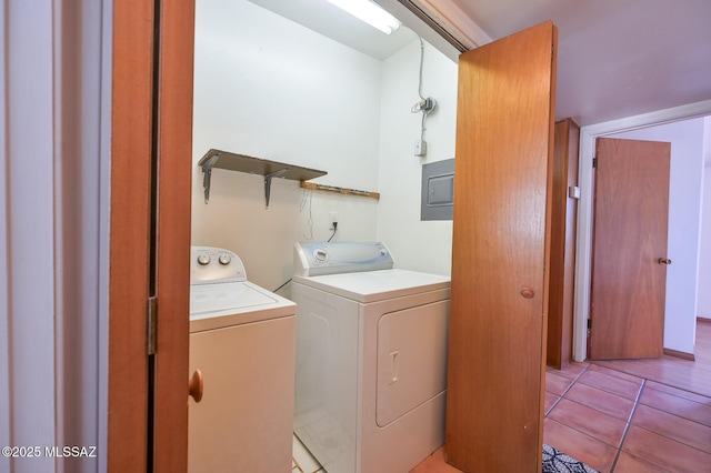 laundry room featuring light tile patterned floors, electric panel, laundry area, and washer and clothes dryer