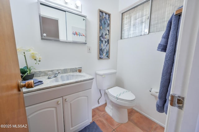 bathroom with vanity, tile patterned floors, toilet, and baseboards