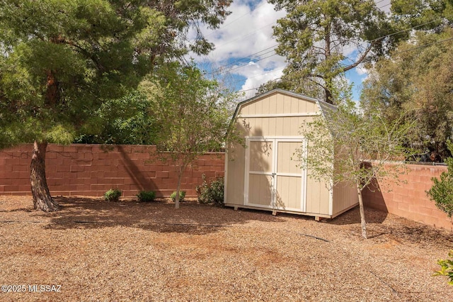 view of shed with a fenced backyard