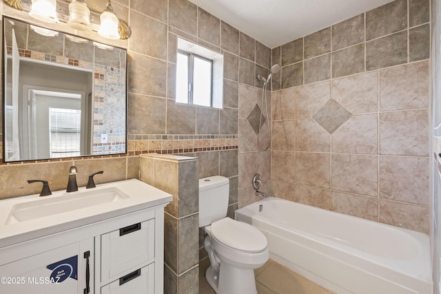 full bathroom with vanity, tile walls, toilet, and tub / shower combination