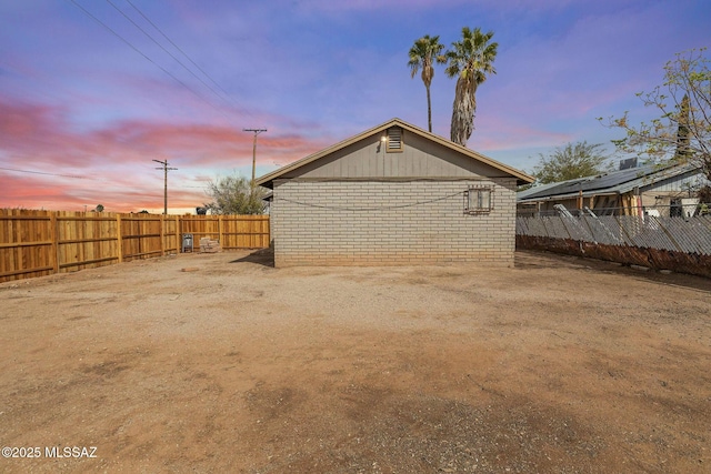 property exterior at dusk featuring fence private yard