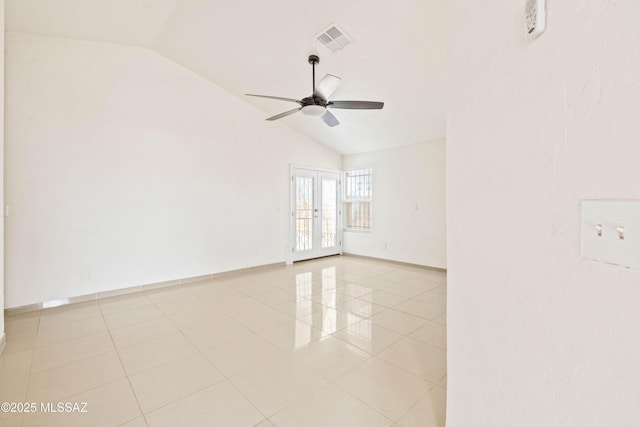 empty room with lofted ceiling, light tile patterned floors, a ceiling fan, and visible vents