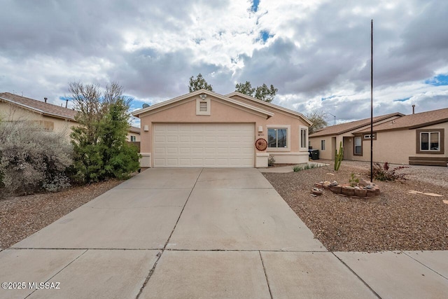 view of front of house with stucco siding, concrete driveway, and a garage