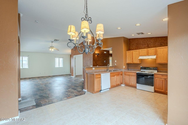 kitchen featuring visible vents, under cabinet range hood, a sink, open floor plan, and white appliances