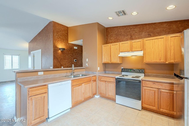 kitchen with white appliances, visible vents, a peninsula, a sink, and under cabinet range hood