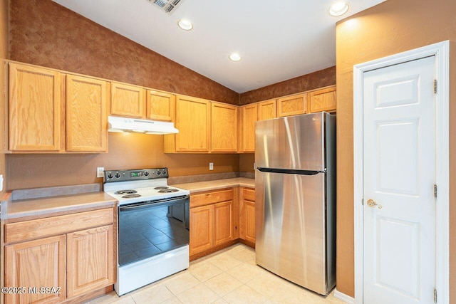 kitchen featuring under cabinet range hood, light brown cabinetry, lofted ceiling, freestanding refrigerator, and white electric stove