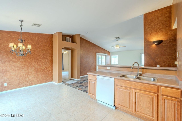 kitchen with dishwasher, arched walkways, visible vents, and a sink