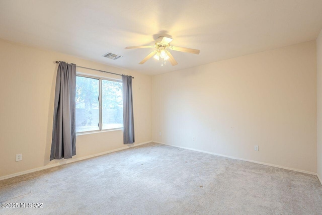 unfurnished room with baseboards, visible vents, carpet floors, and ceiling fan