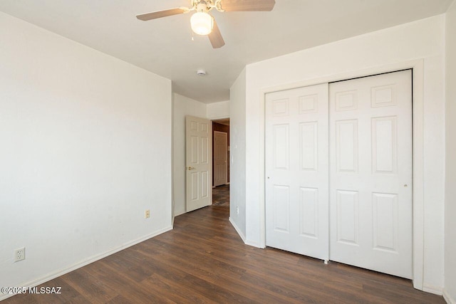 unfurnished bedroom with ceiling fan, a closet, baseboards, and dark wood finished floors