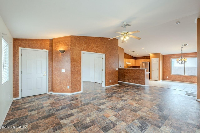 unfurnished living room with visible vents, baseboards, ceiling fan with notable chandelier, and vaulted ceiling