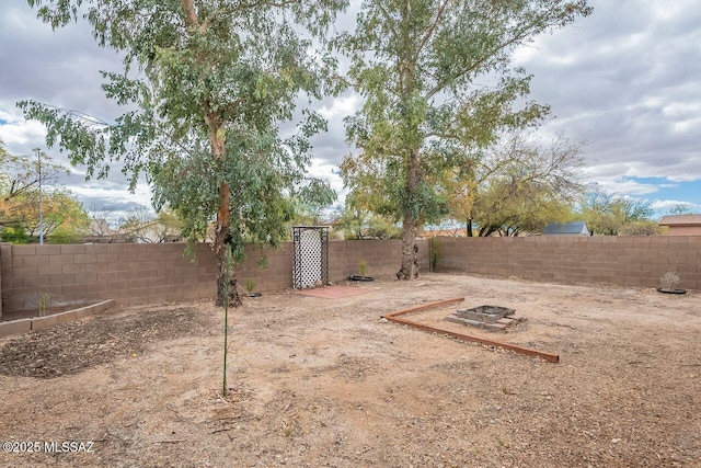 view of yard with an outdoor fire pit and a fenced backyard