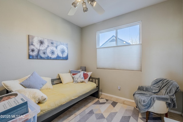 bedroom featuring baseboards and ceiling fan