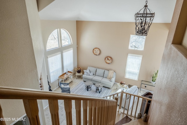 living room featuring a towering ceiling and a notable chandelier