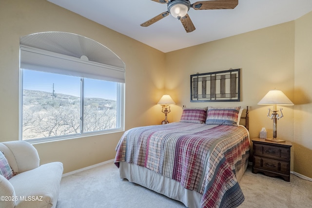 bedroom featuring carpet, baseboards, and a ceiling fan