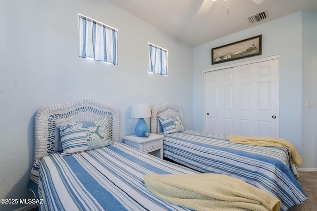 carpeted bedroom featuring visible vents and ceiling fan