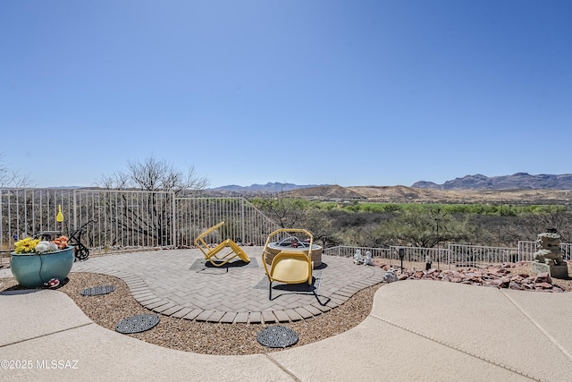 view of patio / terrace with a mountain view and a fenced backyard
