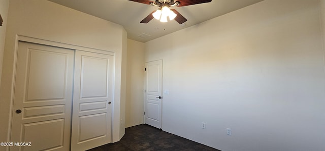 unfurnished bedroom featuring a closet, ceiling fan, and stone finish floor