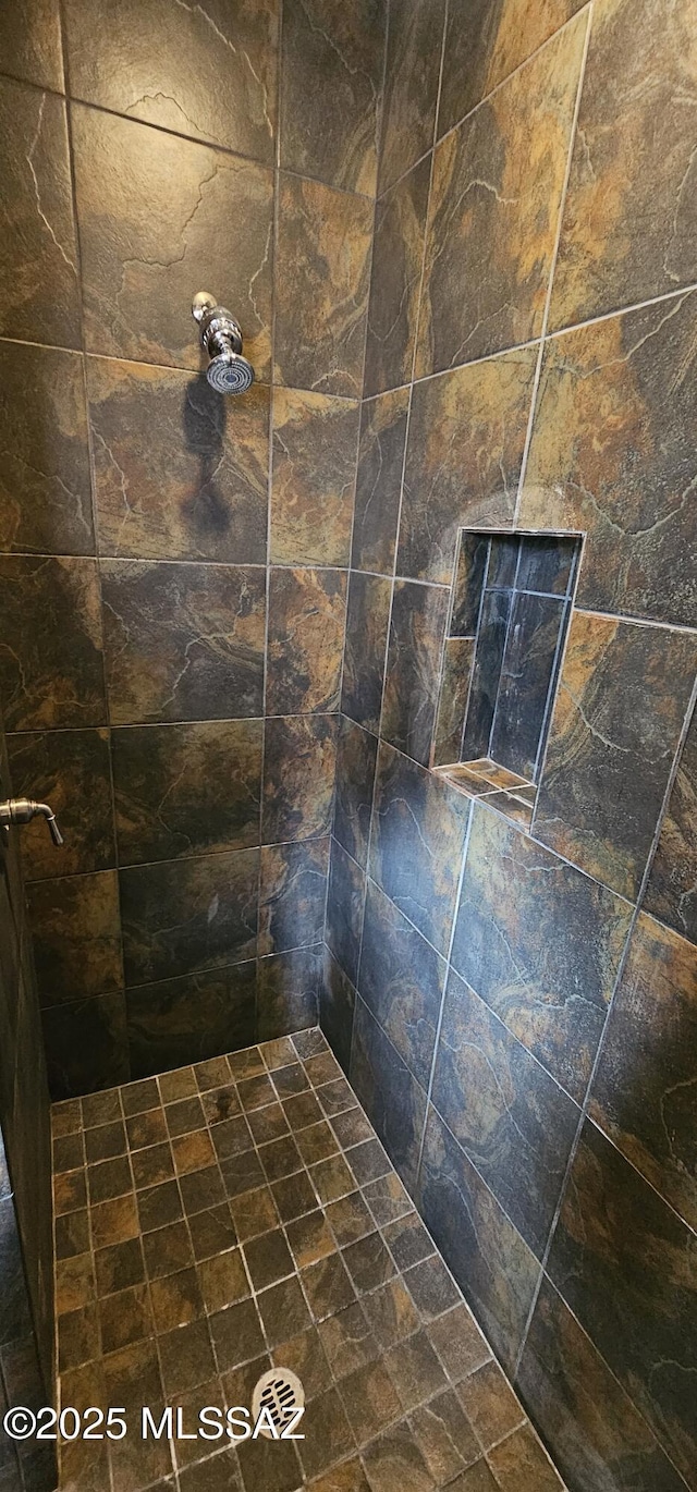 bathroom with a tile shower