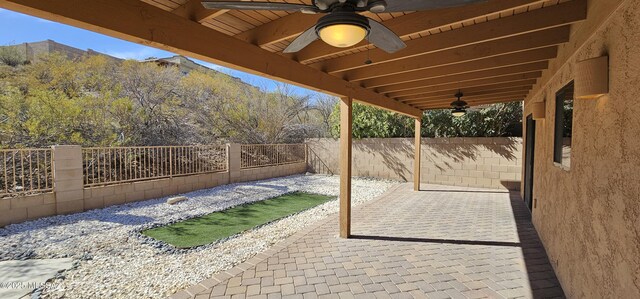 view of patio with a fenced backyard and ceiling fan
