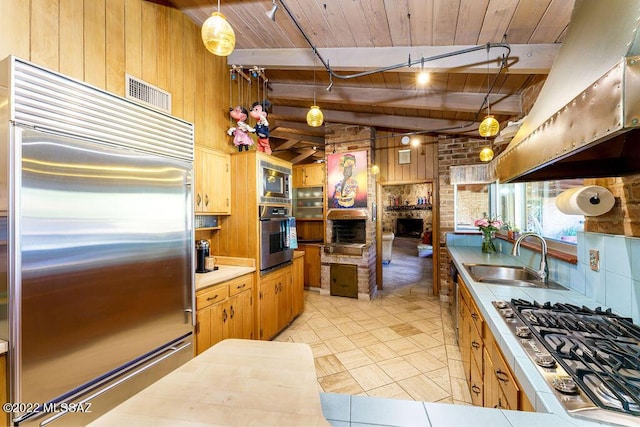 3435 E Via Guadalupe, Tucson, AZ 85716 - kitchen with wood walls, wooden ceiling, a sink, beamed ceiling, and built in appliances