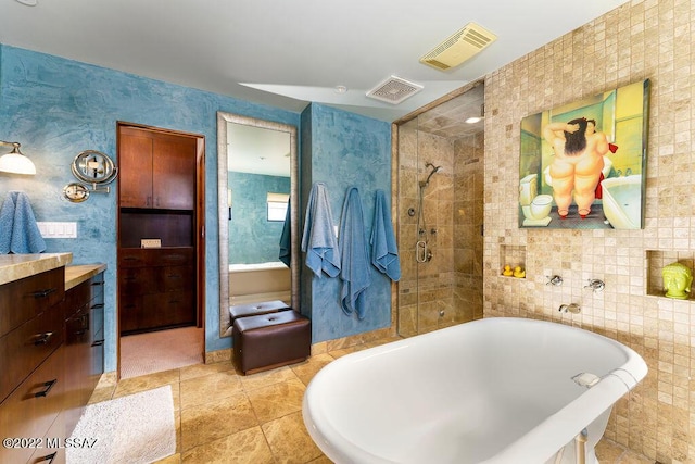 3435 E Via Guadalupe, Tucson, AZ 85716 - bathroom featuring a freestanding bath, tile walls, visible vents, and a stall shower