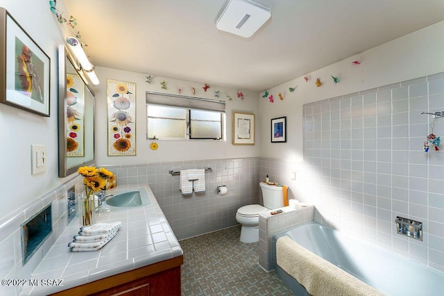 3435 E Via Guadalupe, Tucson, AZ 85716 - bathroom featuring vanity, tile walls, a tub, a wainscoted wall, and toilet
