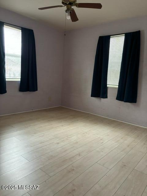 unfurnished room featuring a ceiling fan and light wood-style floors