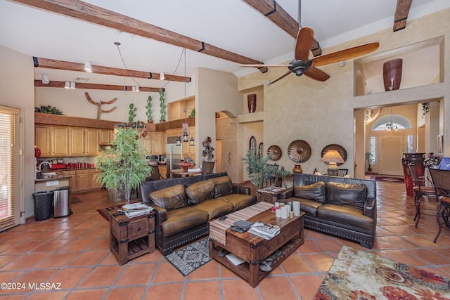 living room featuring light tile patterned floors, beam ceiling, a towering ceiling, and a ceiling fan