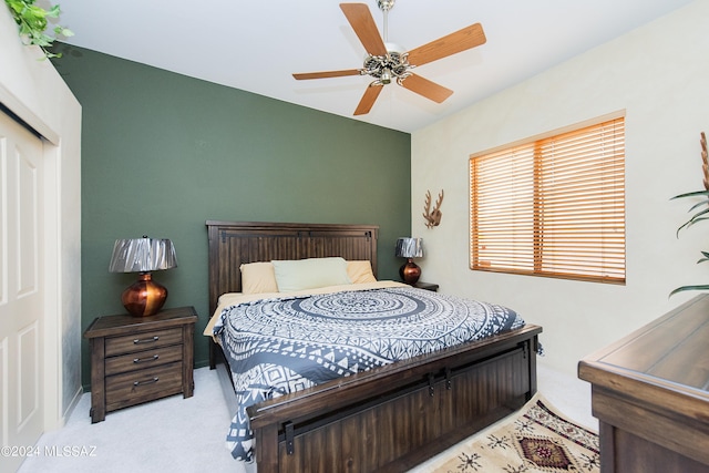 carpeted bedroom featuring a closet and ceiling fan