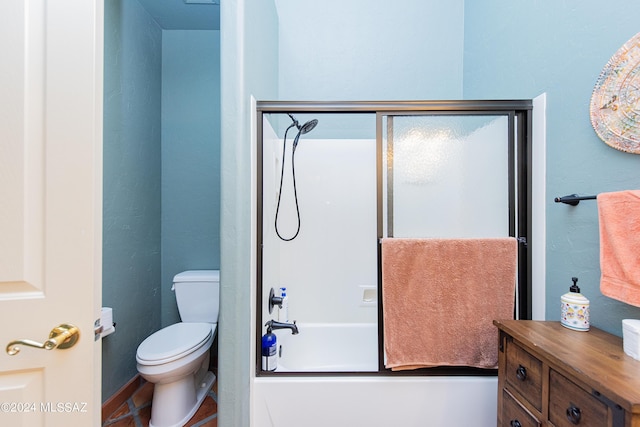 bathroom featuring bath / shower combo with glass door and toilet