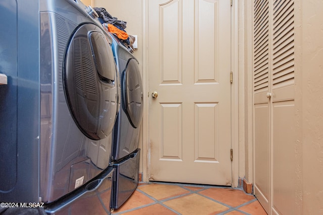 clothes washing area featuring light tile patterned floors, laundry area, and independent washer and dryer