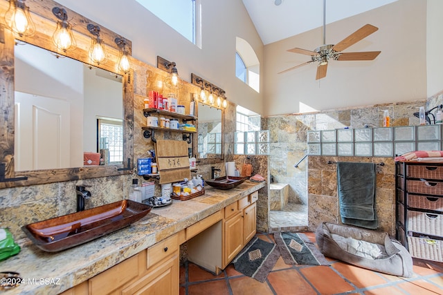 bathroom with tile patterned flooring, a walk in shower, double vanity, high vaulted ceiling, and a ceiling fan