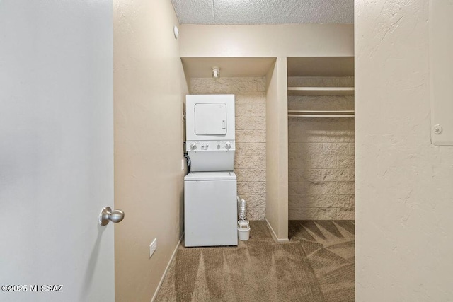 clothes washing area with carpet, stacked washer and clothes dryer, and a textured ceiling