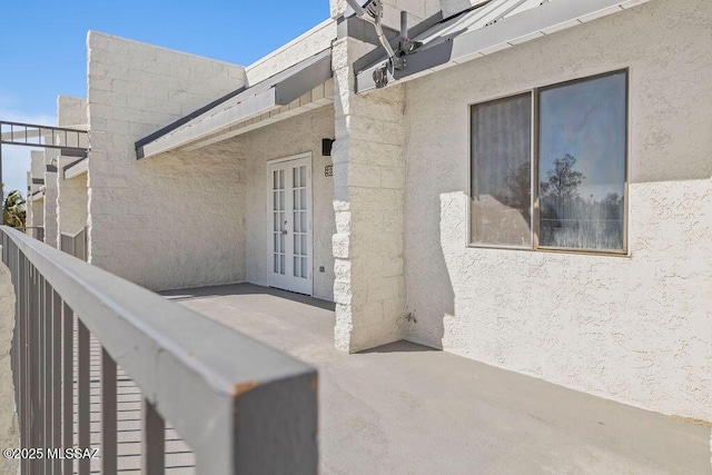 doorway to property featuring stucco siding and a patio