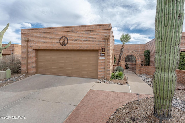 view of front of property with a gate, a garage, and driveway