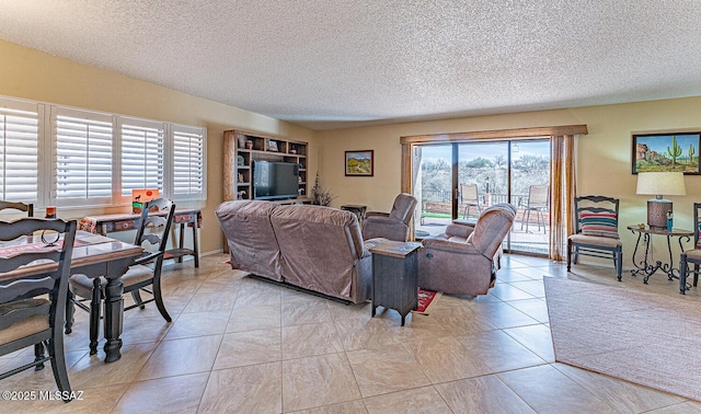 living area with light tile patterned floors and a textured ceiling