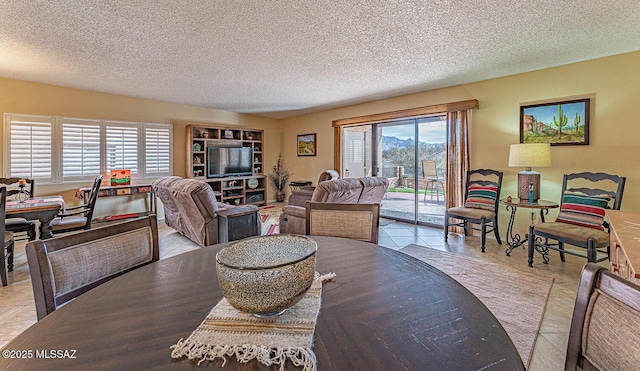 dining area with tile patterned floors and a textured ceiling