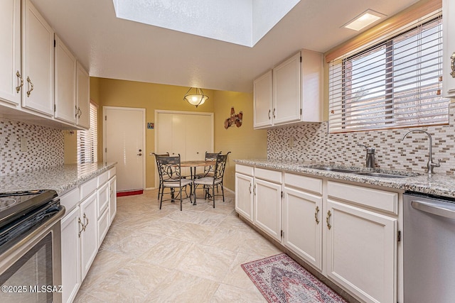 kitchen with decorative backsplash, stainless steel appliances, and a sink