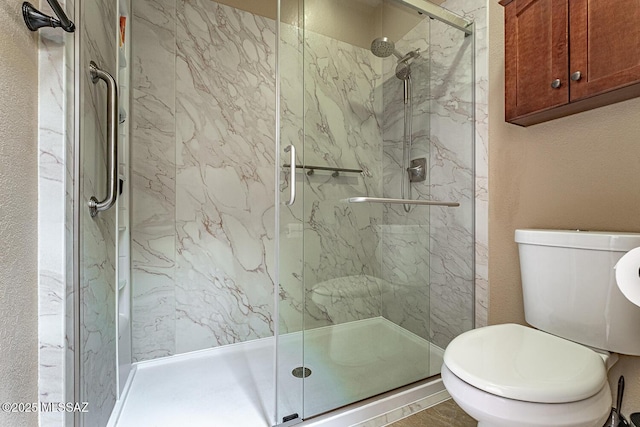 full bathroom with a marble finish shower and toilet