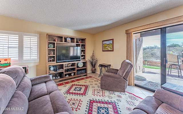 tiled living area featuring baseboards and a textured ceiling